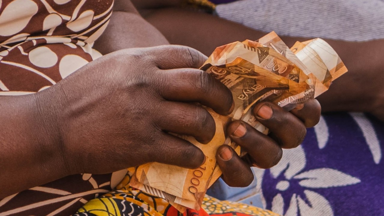 Community members counting their weekly savings.