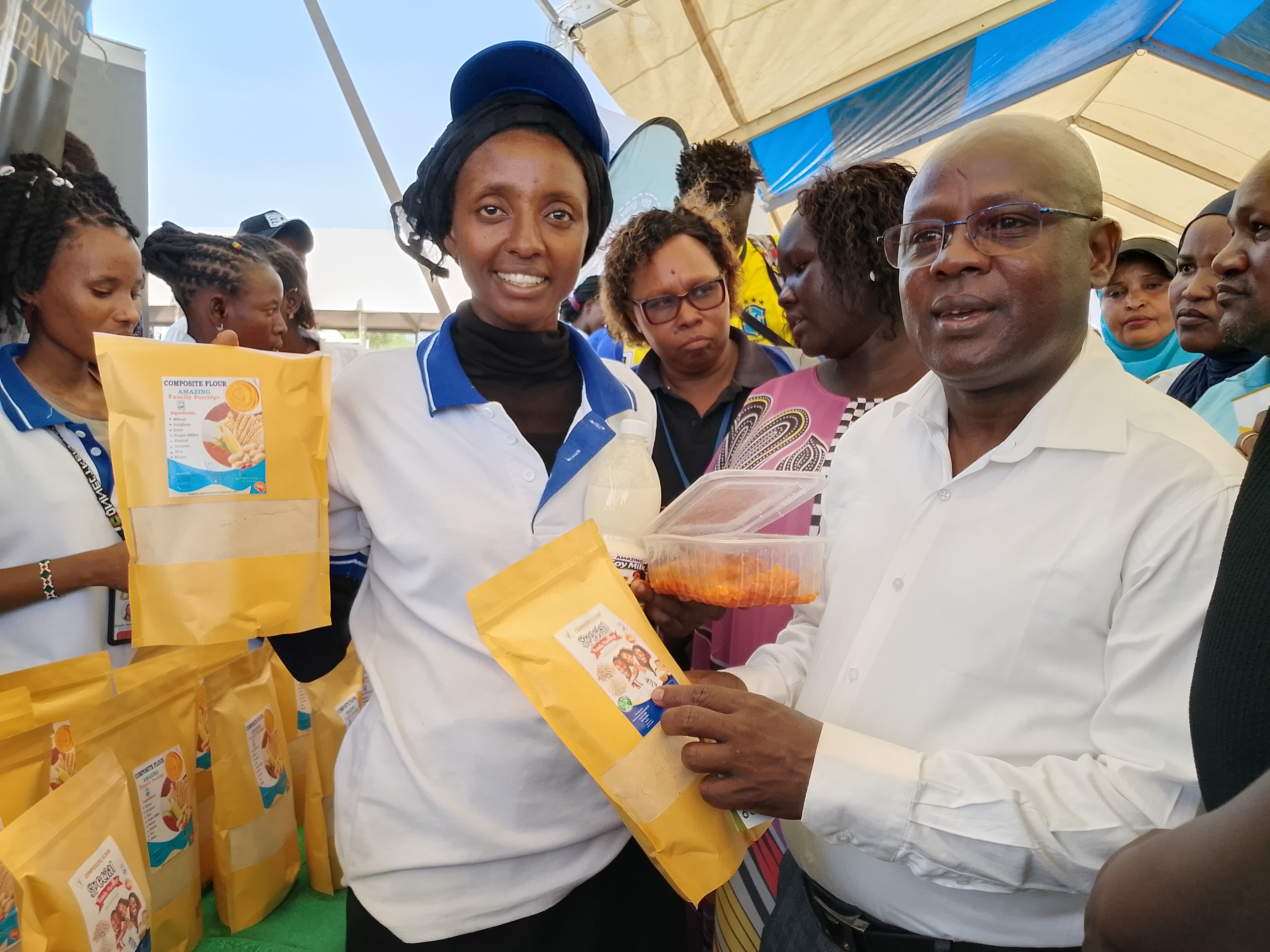 Deputy Governor Dr John Erus (middle in white shirt) leads Government and development partners representatives visiting exhibition booths at the KKCF trade fair